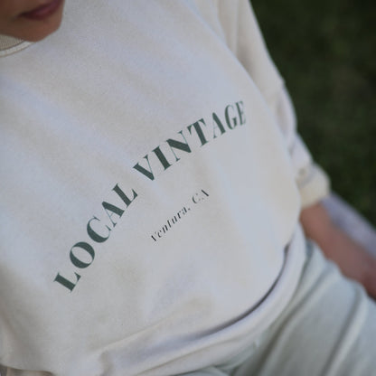 White sweatshirt with 'LOCAL VINTAGE' text on a person wearing it.