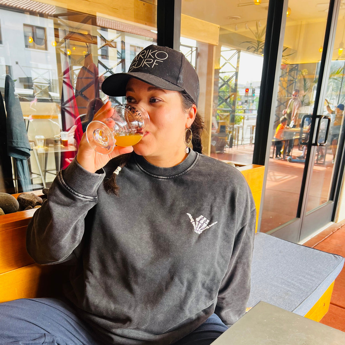 Person drinking from a glass in a casual setting